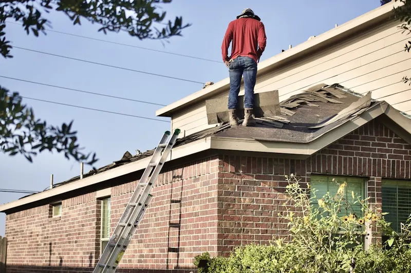 Professional roofer working on a residential roof in North Palm Trail